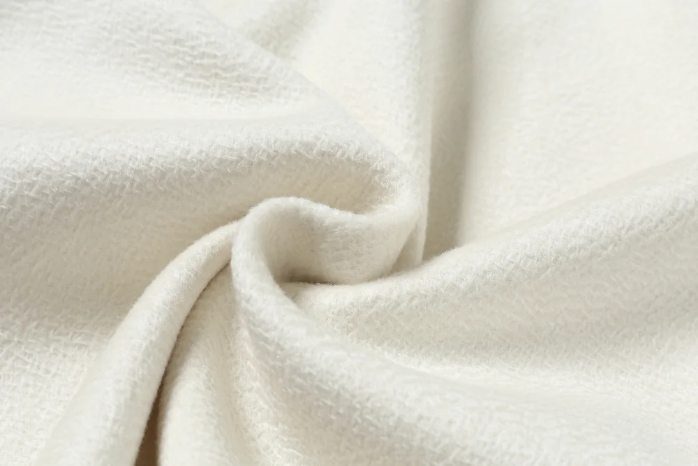 Ivory fabric photographed for TINGSU, showing the brushed ripple surface