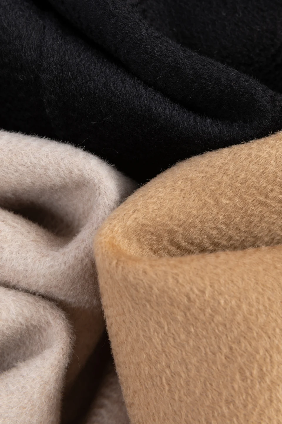 Original TINGSU photograph of black, light neutral and camel fabrics layered together