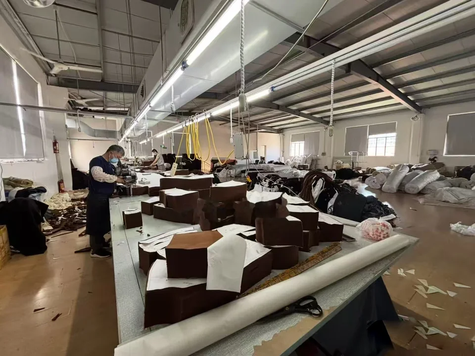 Long worktables with cut fabric pieces and material in a cutting workspace